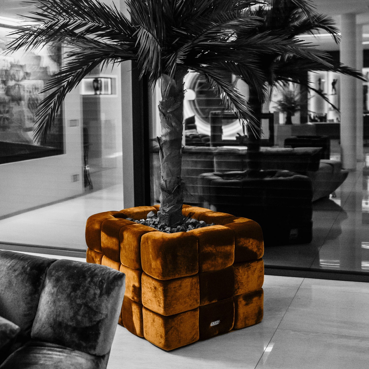 Goldener Velvet Blok neben einer modernen Couch 